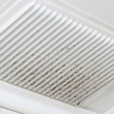 What are the common causes of poor airflow from my AC vents?